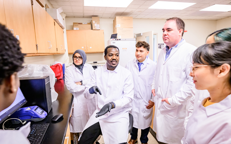 Student researchers work in the lab with Dr. Christopher Gaulke.