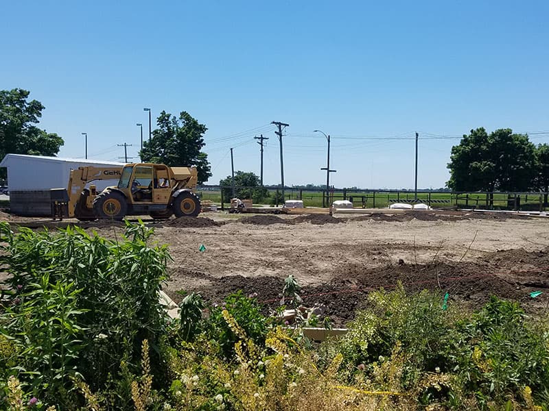 Begin Construction. Ground breaking with machinery