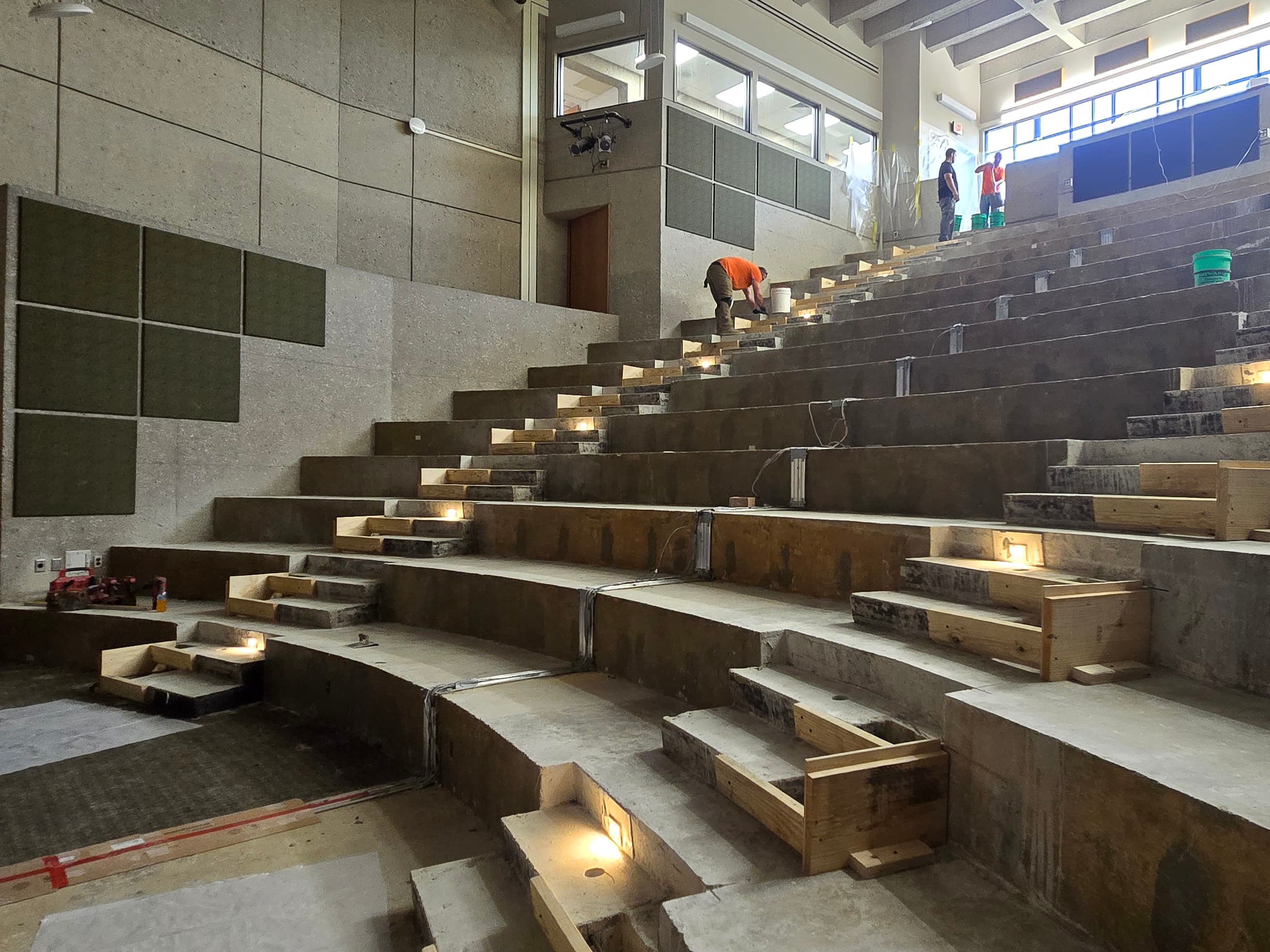 Full indoor shot of a large amphitheater or auditorium under construction.
