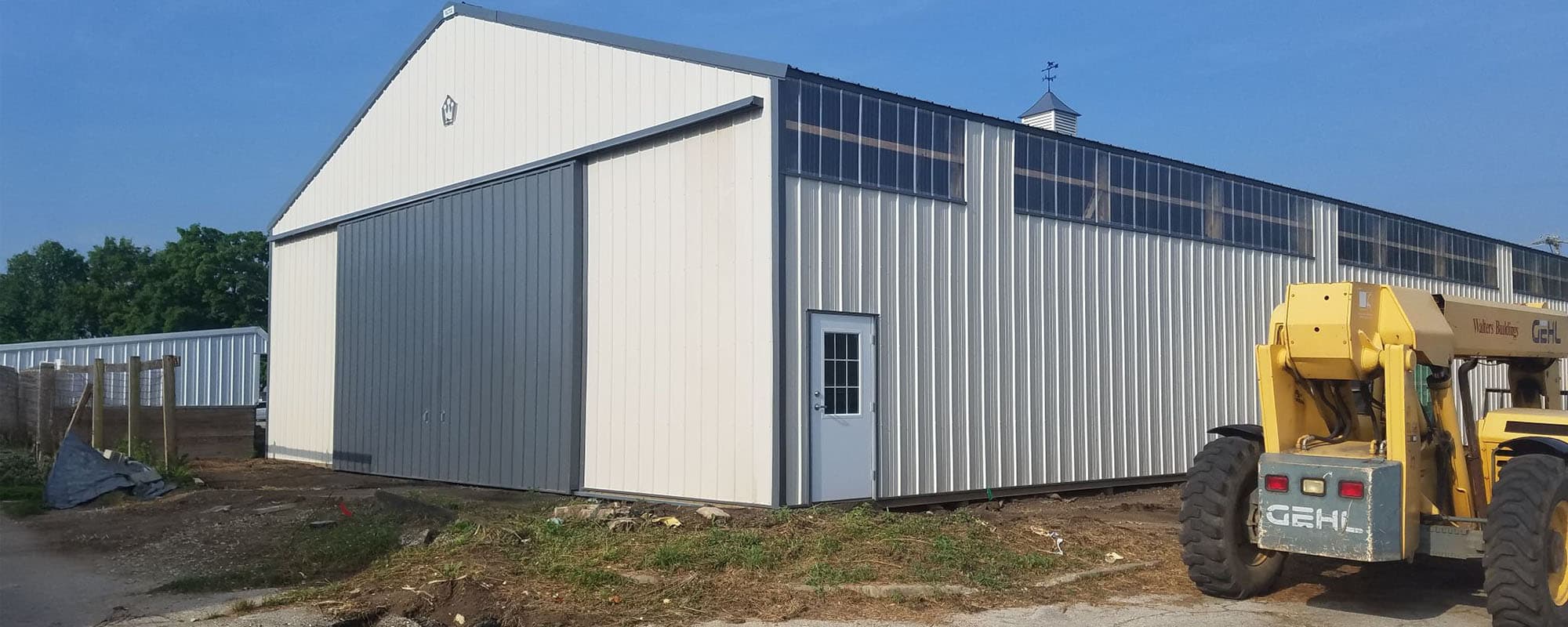 Lameness Arena building completed. Machine setting near completed pole barn construction.