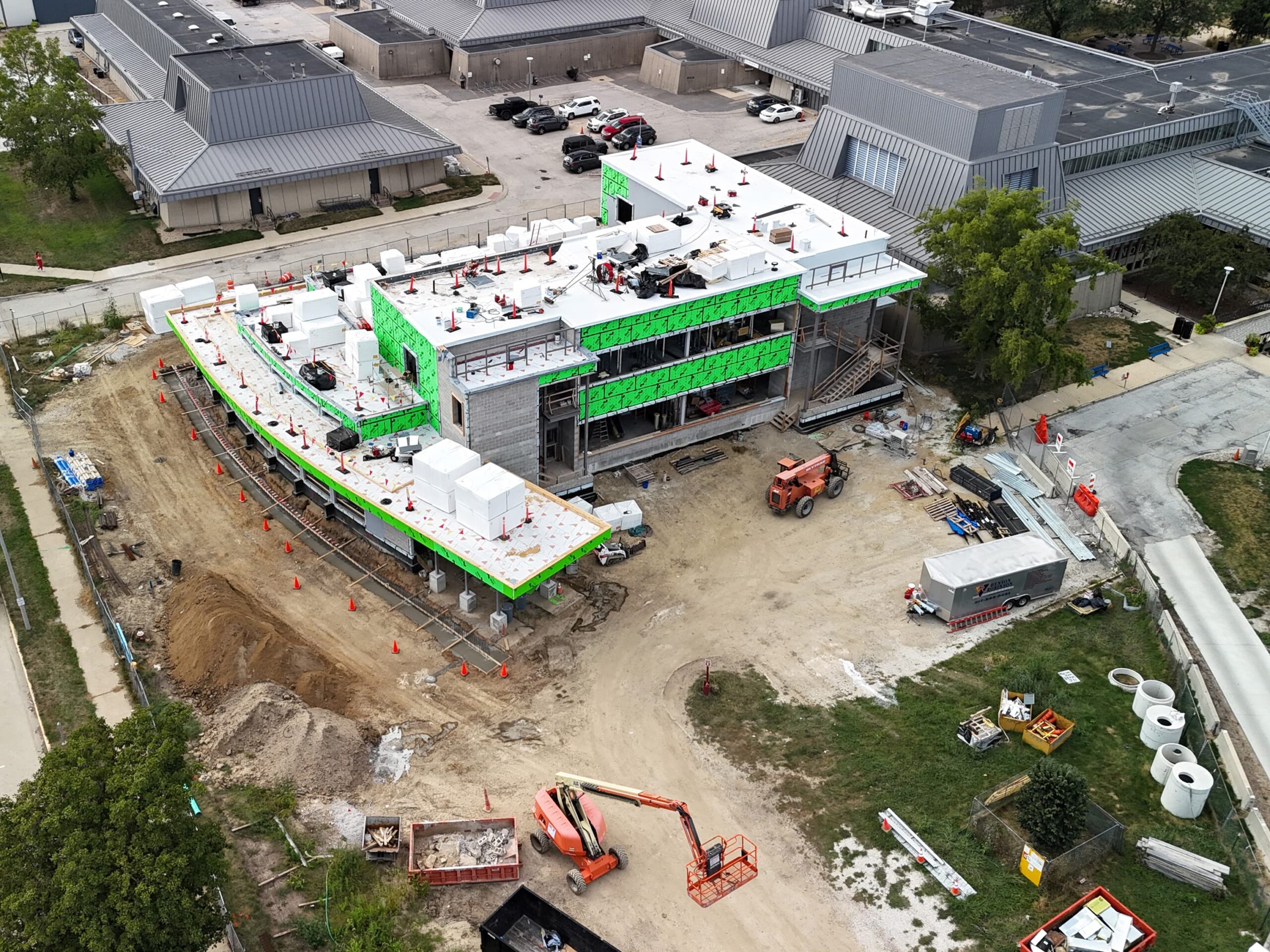 Aerial view of a modern building under construction with a curved design.