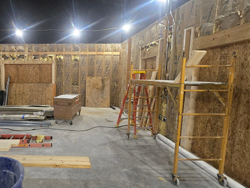 Construction progress inside the Wildlife Education Classroom at the University of Illinois College of Veterinary Medicine, showing framed walls, insulation, and scaffolding as the space is prepared for wildlife education exhibits and programs.