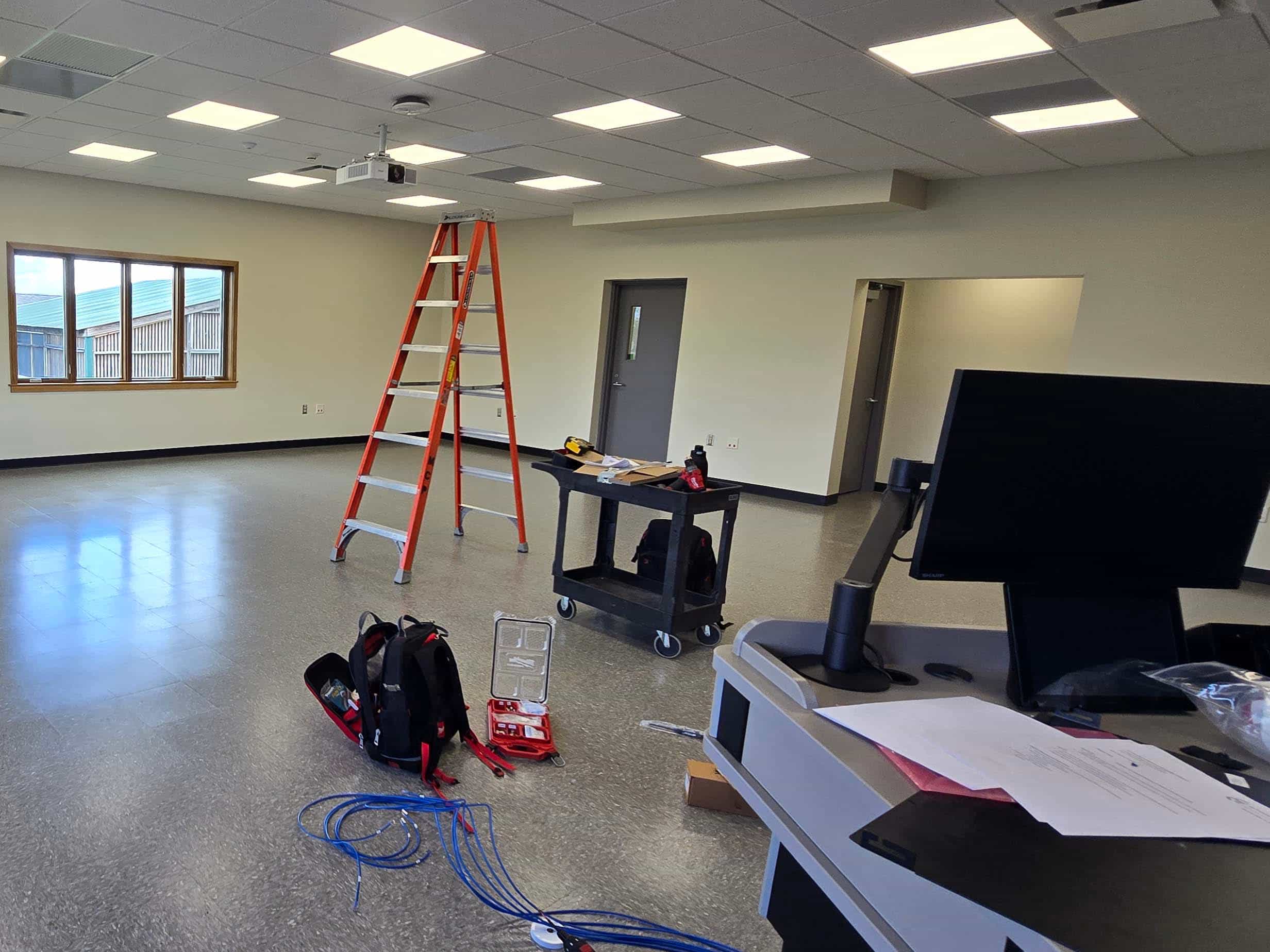 Interior of the Wildlife Education Classroom at the University of Illinois College of Veterinary Medicine with ceiling projector and installation equipment.