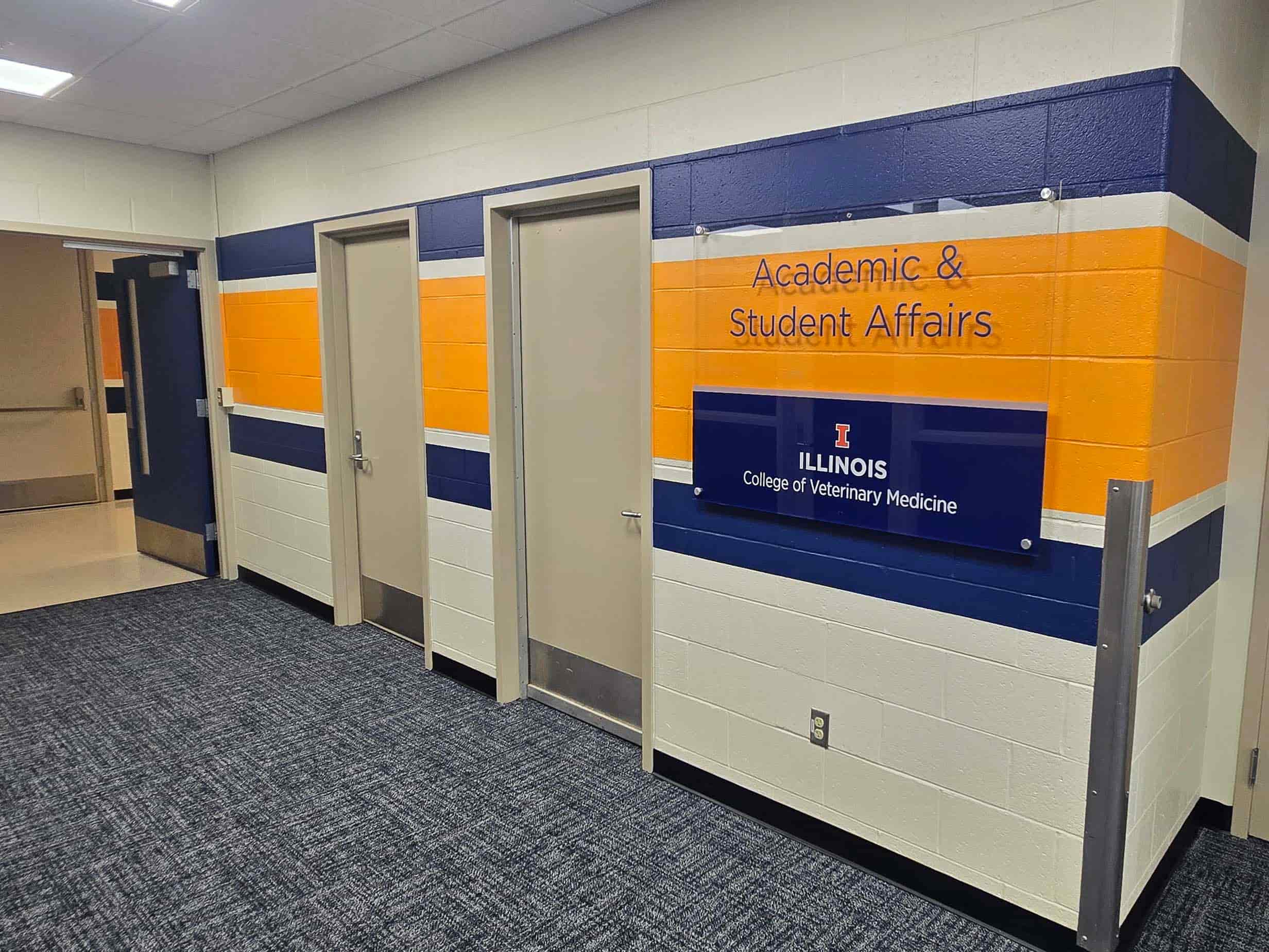 Hallway outside Academic & Student Affairs offices with University of Illinois signage and two office doors.