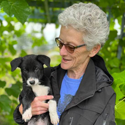 Dr. Marcella Ridgway holding a black and white puppy