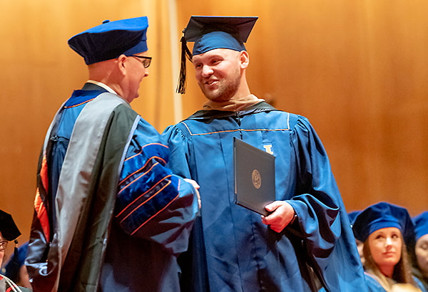 MVS Student shaking hands with faculty at convocation