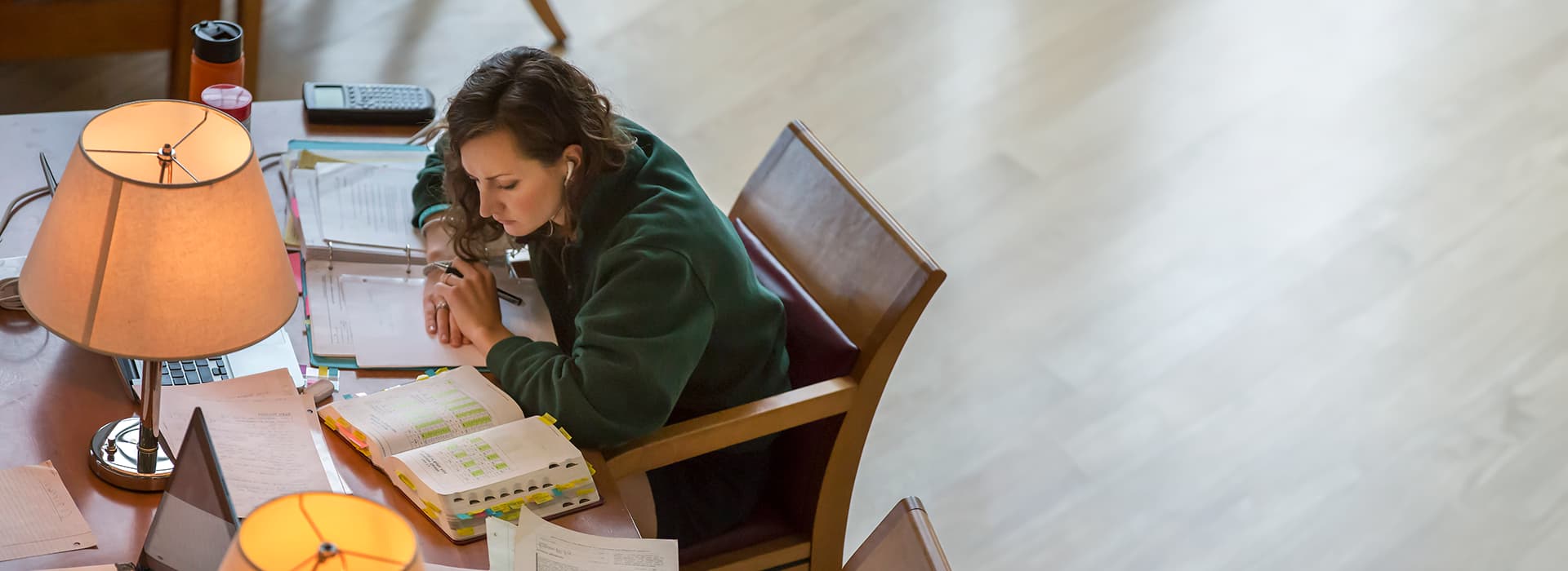 Student reading at table.