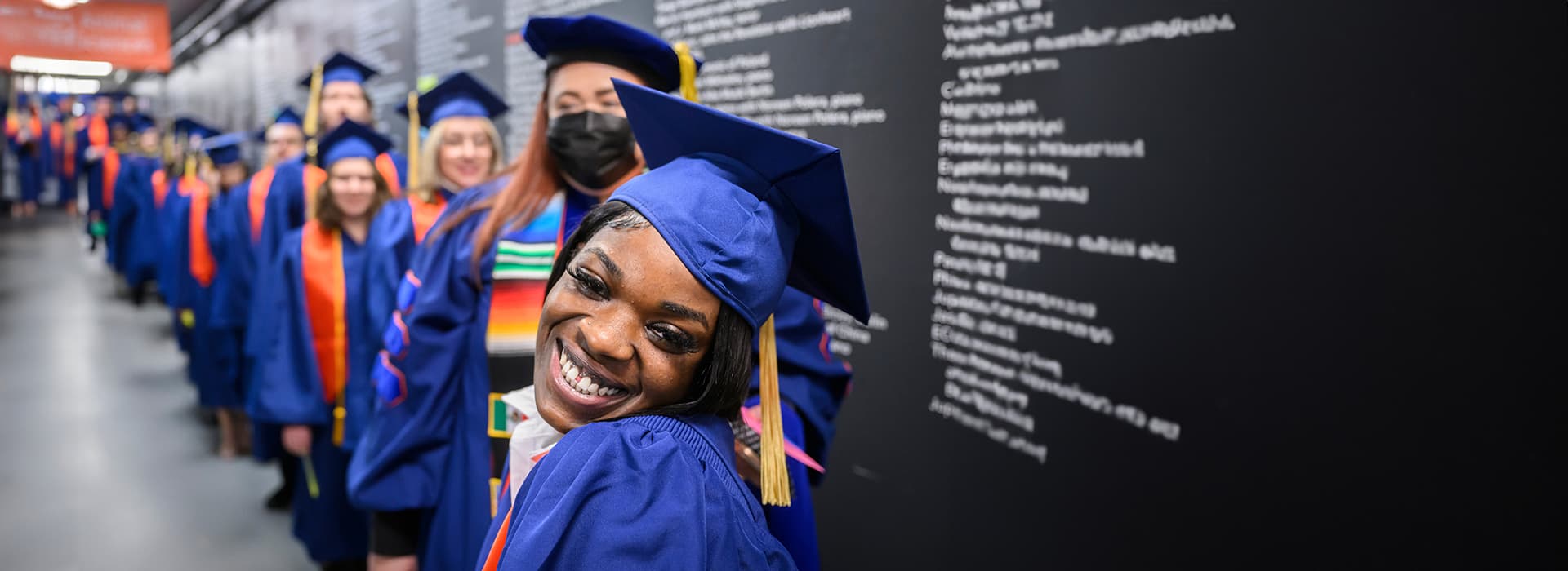 Smiling student dressed for graduation.