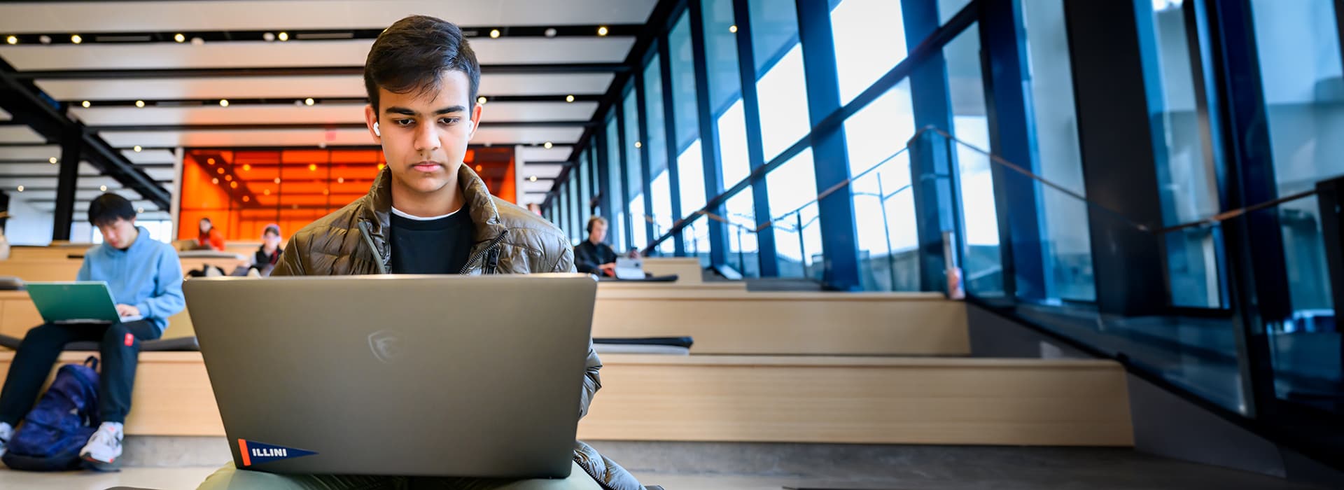 Student looking at laptop.