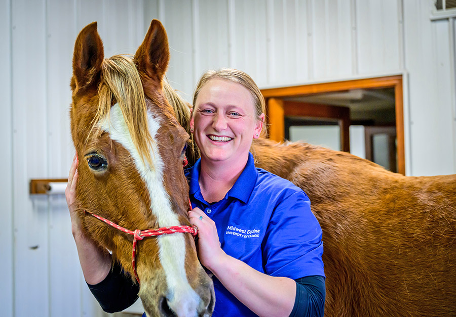 Dr. Catherine "Cat" Foreman-Hesterberg smiling with a brown horse