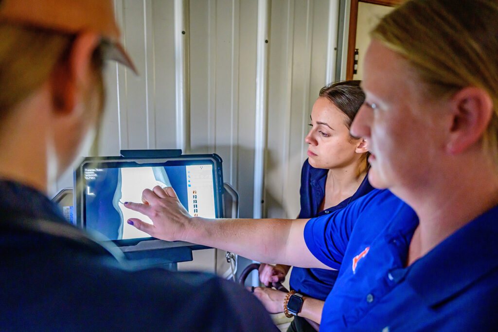 Dr. Catherine "Cat" Foreman-Hesterberg pointing at a virtual image next to colleagues