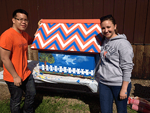 veterinary students with painted doghouse