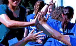 [students giving high fives]