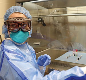 Alex Gochenauer demonstrates the proper PPE for the chemo preparation