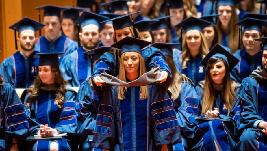 Graduate of the College of Veterinary Medicine getting hooded by her mentor