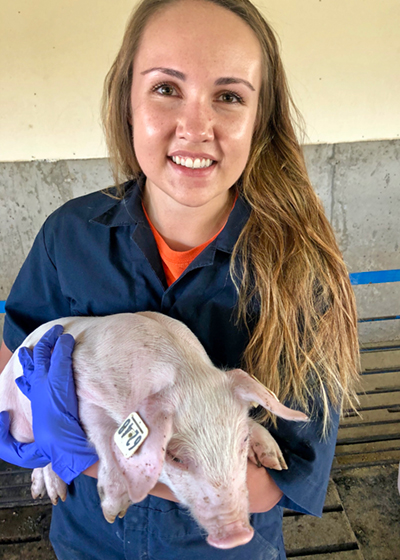 [Erin Kettelkamp holding a pig]