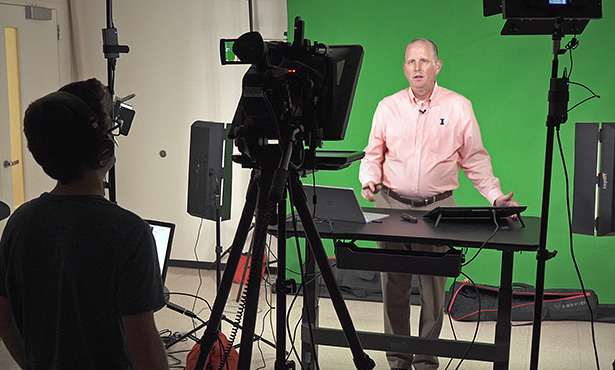 [Dr. Jim Lowe presents a webinar in front of a green screen]