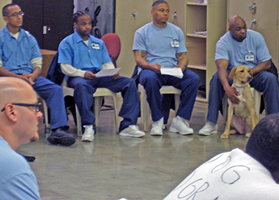 Inmate handlers attend a presentation