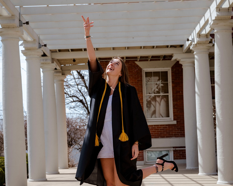 annie davis tossing her graduation cap into the air