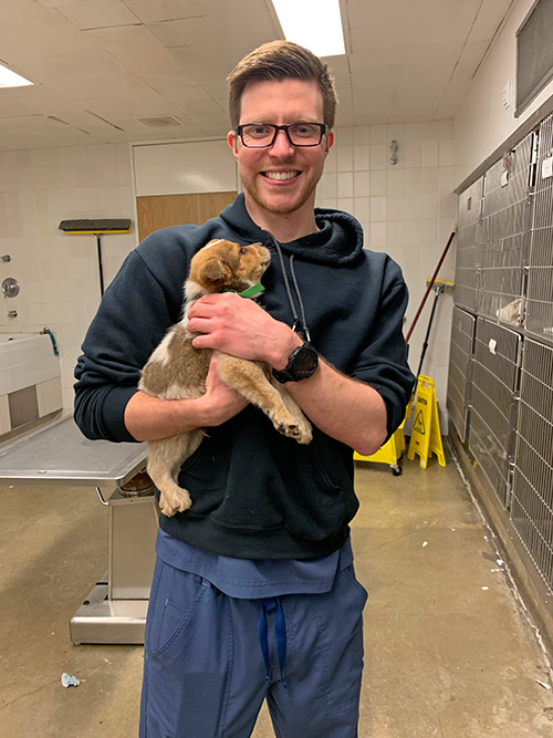 Andrew Bullis as a vet student with a junior surgery patient