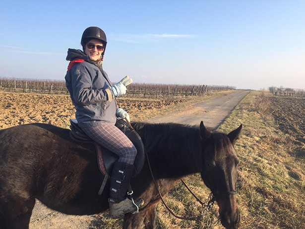 Dr. Natalie Arruda Bergamaschi riding a horse