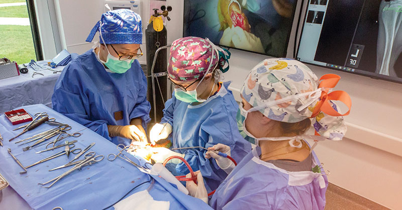 three surgeons in an OR