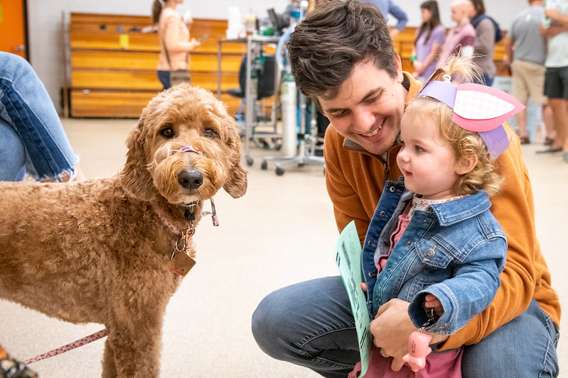 little girl in headband encounters dog