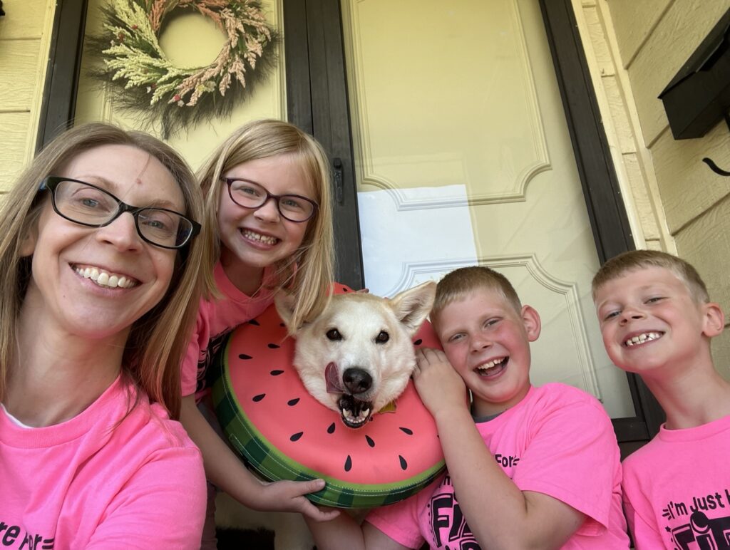 Angela Cravens in a selfie with her three kids and white husky, Iris. 