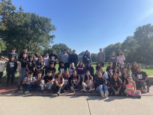 The Latin Village bus cohort pose in front of Foellinger Auditorium