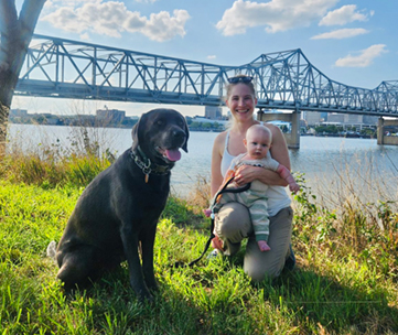 Dr. Michelle Borsdorf with Labrador retriever, Scoter, and young child