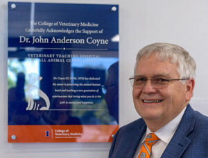 Dr. John Anderson Coyn with the plaque naming the renovated Small Animal Clinic client lobby after him