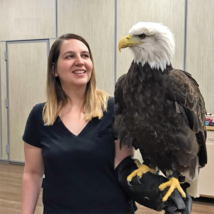 Dr. Mariana Sosa-Higareda holds an eagle on her arm.