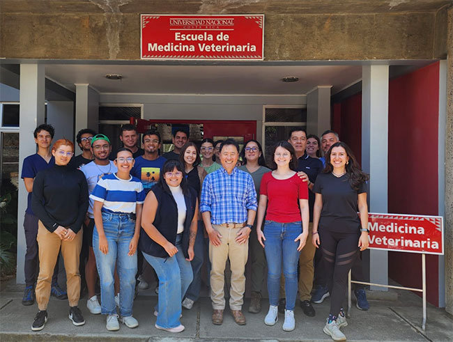 Dr. Ko standing with a group of students