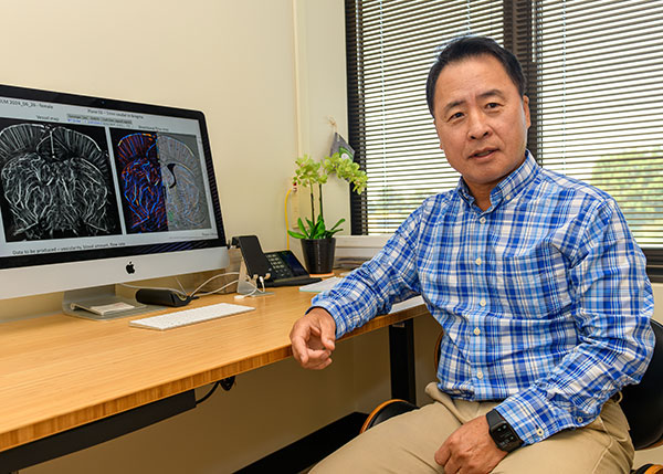 Dr. CheMyong Jay Ko in his office, showing a new research interest on the screen of his computer