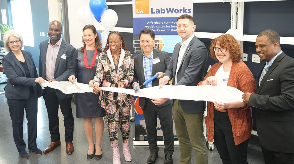 Dr. Ko and others cut the ribbon during the grand opening of LabWorks