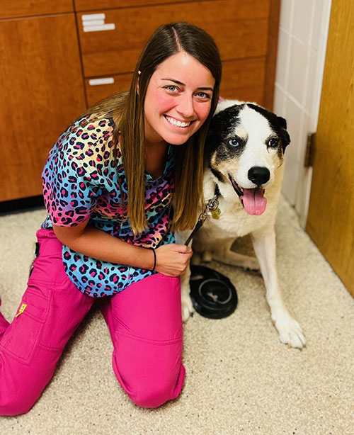 Sheldon poses with Tara, a vet tech in oncology