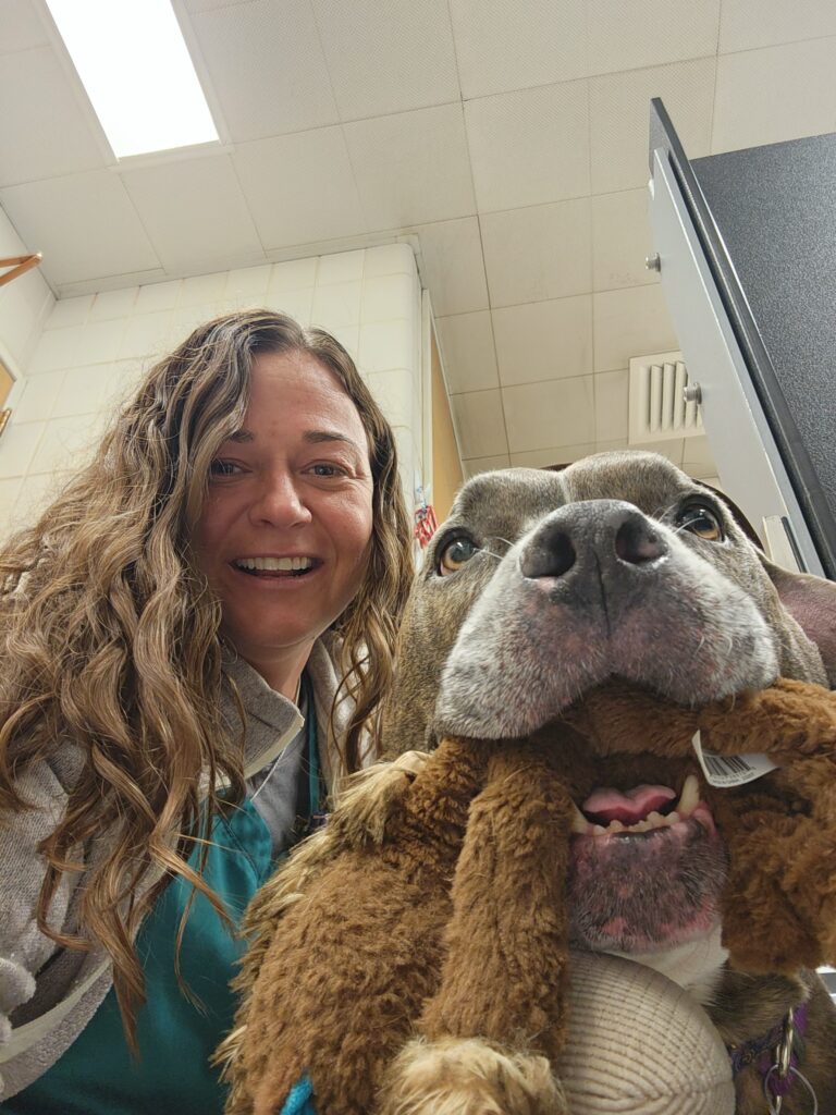 Kim Knap with a dog with a toy in his mouth.