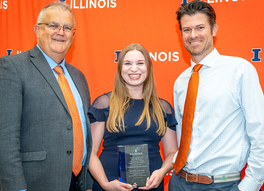 Dean Peter Constable and Dr. Chris Dupuis congratulate Dr. Sarah Wright, winner of the Outstanding Young Alum award in 2024