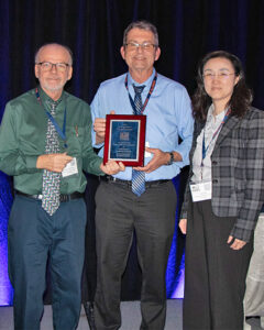 Dr. Jay Calvert (center) accepts the award from Drs. Bob Rowland and Ying Fang.