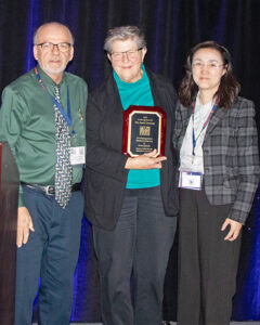 Dr. Joan Lunney (center) accepts the award from Drs. Bob Rowland and Ying Fang.