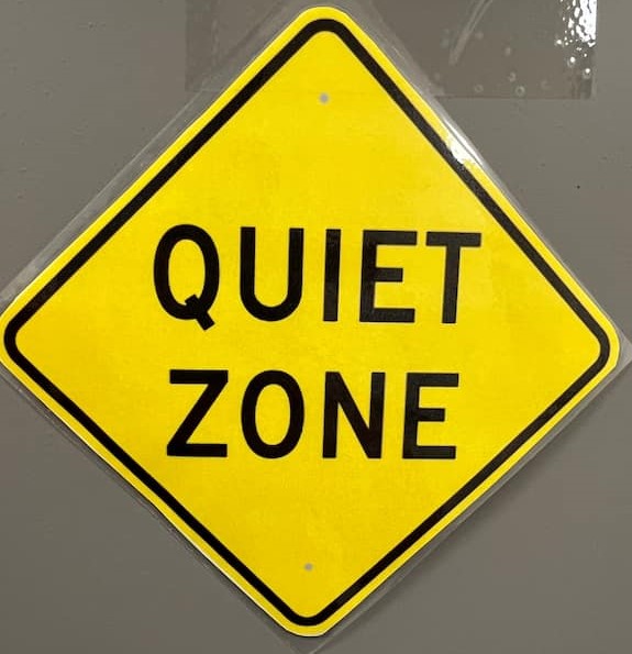 A "quiet zone" yellow sign on a door.