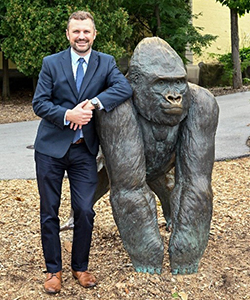 Dr. Michael Adkesson with an ape statue