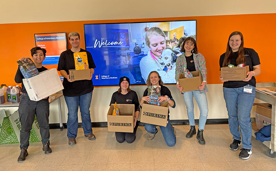 Members of the Illinois VOICE chapter holding donation boxes from their pet pantry outreach event.