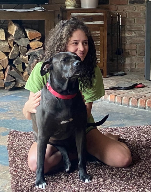 Alyssa poses with her dog at home