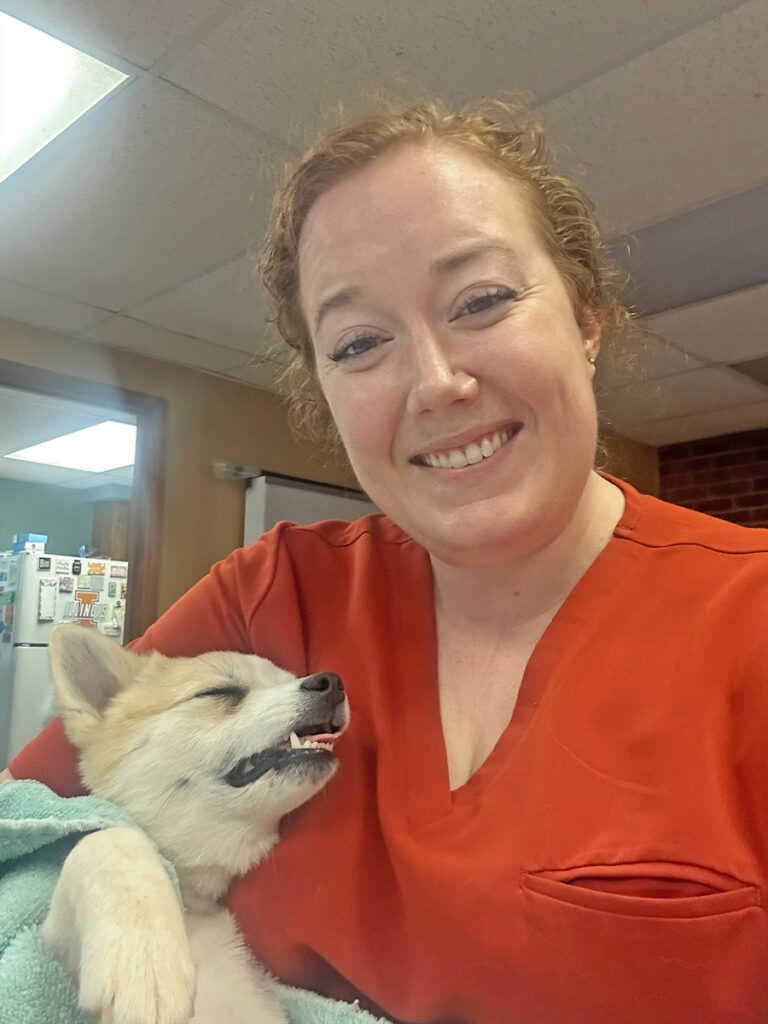 Veterinarian holding a sleeping dog.