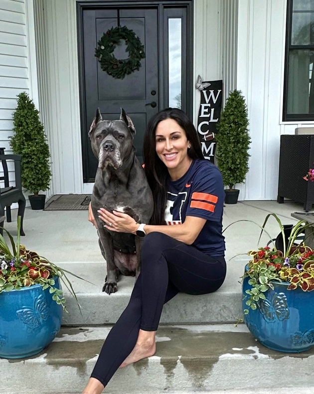 Paige Roytek sitting on front steps with dog Khloe