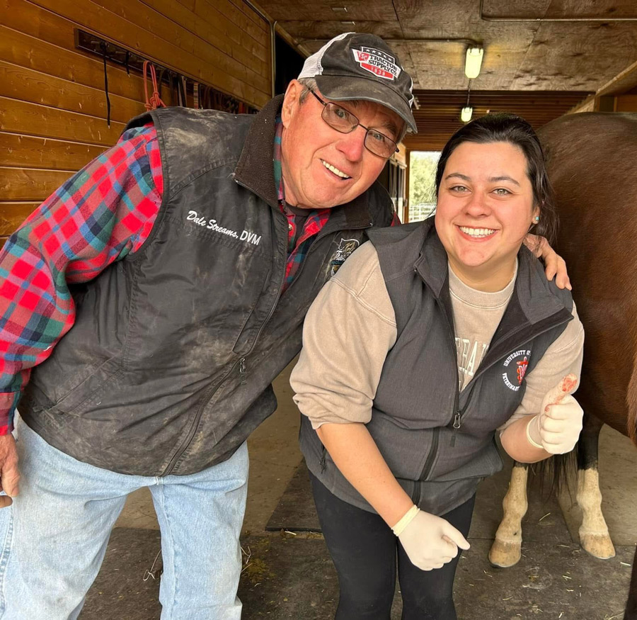 Hannah Streams and her dad, Dale Streams, posing next to a horse.