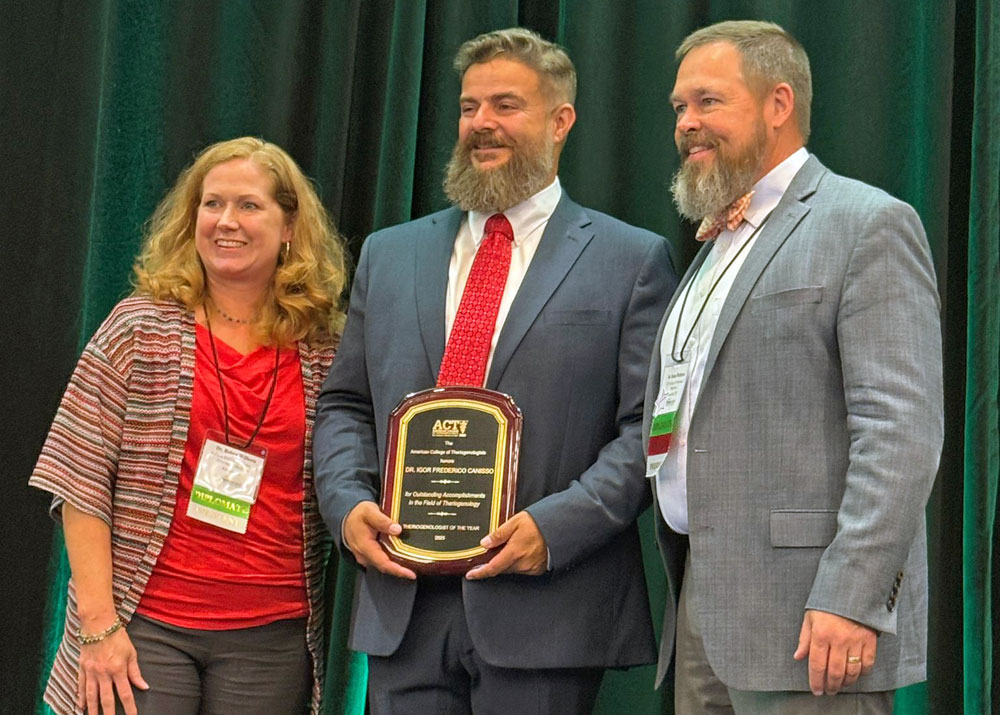 Dr. Igor Canisso (center) received the Theriogenologist of the Year award in 2025 from leaders of the American College of Theriogenologists