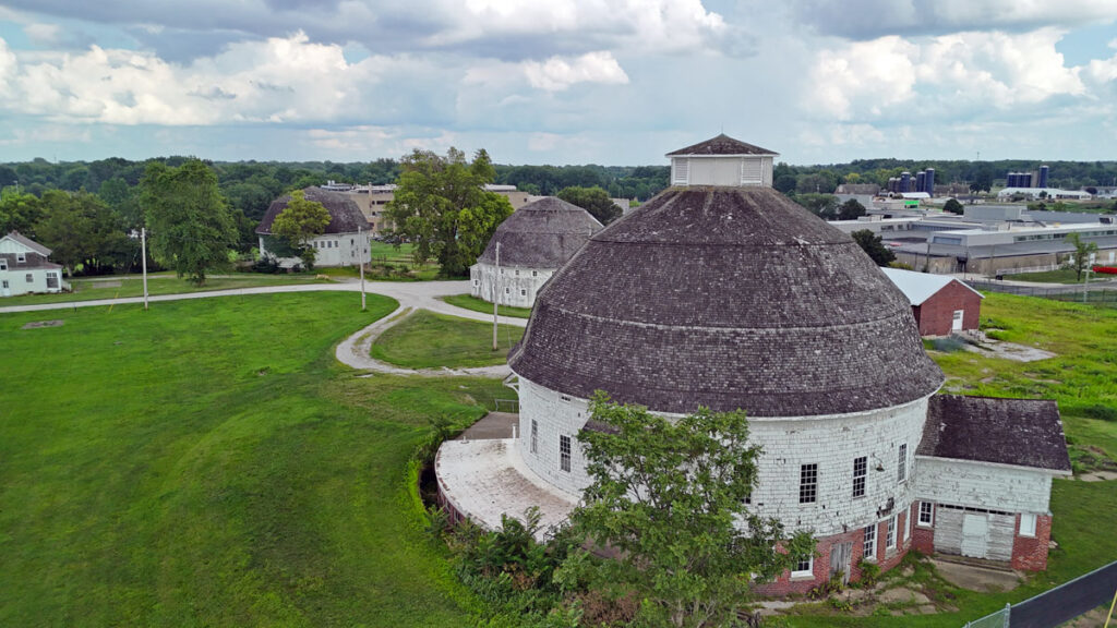 three U. of I. round barns viewed from above from the northwest, with college of veterinary medicine buildings visible behind.