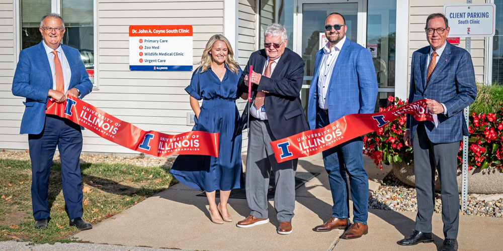 Dr. John Coyne cuts ribbon in front of clinic bearing his name